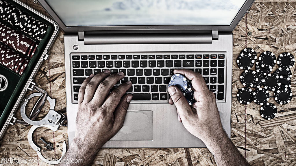 Online poker playing with laptop with wooden b Online poker playing with laptop with wooden b